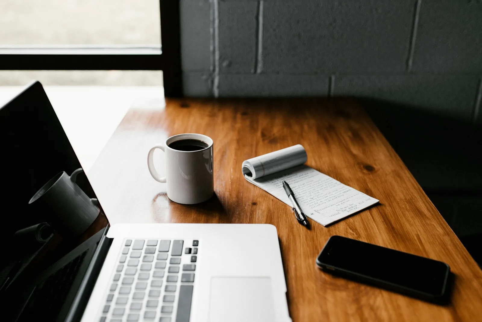 A notebook and coffee on a desk